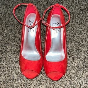 Red heels with strap around the ankle!